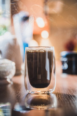 Double exposure of hot coffee and beans