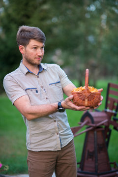 A man holding a basket full of orange edible mushrooms - chanterelles in autumn