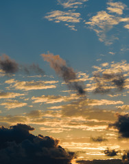 Dramatic sunset sky with orange colored clouds.