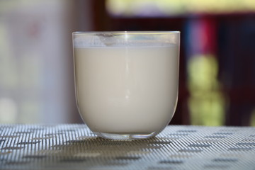 glass of milk and glass of milk on wooden table
