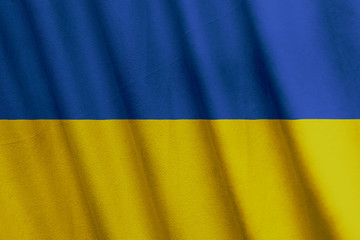 Waving Ukrainian flag with a fabric texture