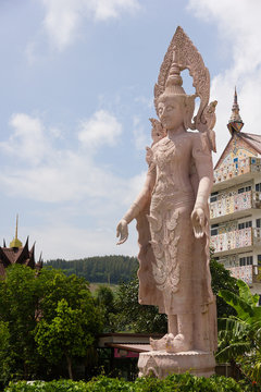 Angel statue at Wat Phra Thad Pha Son Kaew Petchabun ,Thailand  with the background has a white cloud and blue sky.