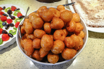 Dish of lokmades, a fried doughnut coated with syrup