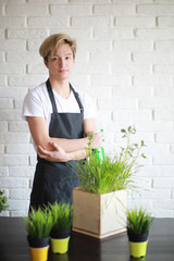 Young Asian boy takes care of indoor plants