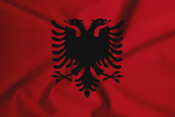 Waving Albania flag with a fabric texture