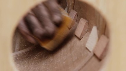Artisan Sanding the Wood. Manufacture of a Musical Instrument.
