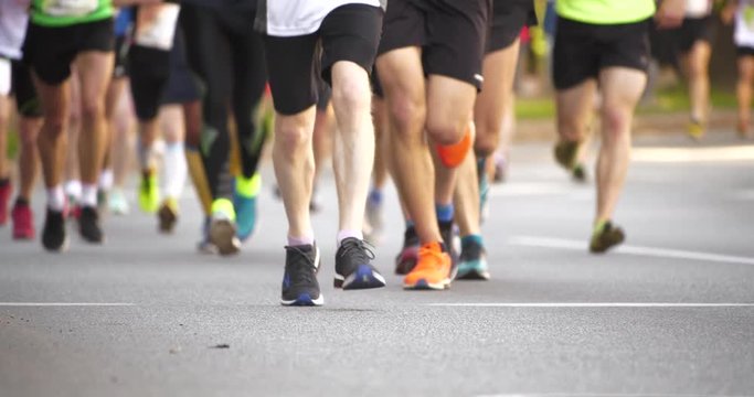 4K - Crowd of athletes at the marathon. bottom view