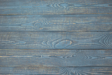 Background of wooden texture boards with remnants of light blue paint. Horizontal.