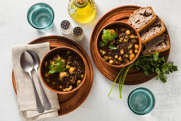 Moroccan black lentil soup with chickpeas and cauliflower in bowls on the table. healthy vegan...