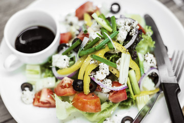 traditional greek salad with feta cheese and mixed organic vegetables