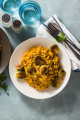 risotto with pumpkin and brussels sprouts on the table. A healthy recipe for the whole family. festive table