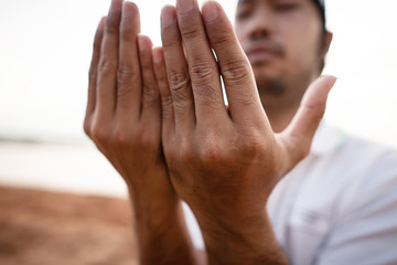 Close-up: Muslim men are praying for blessings from God