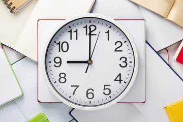 wall clock and open notebook or book
