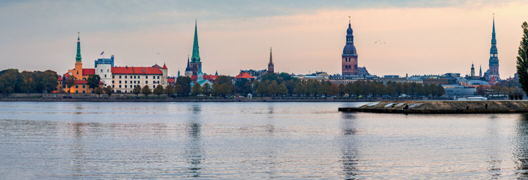 Churches of old Riga city, panoramic view from waterfront of the left bank of Daugava river © sergei_fish13