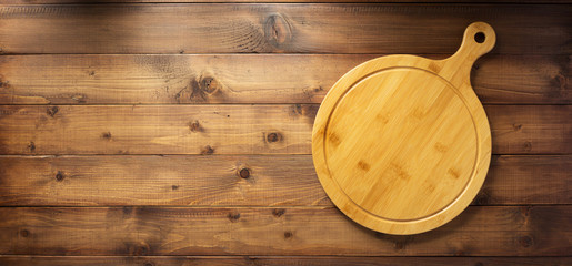 pizza or bread cutting board at wooden table