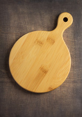 pizza or bread cutting board at wooden table