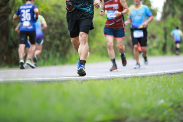 Group of people running race marathon