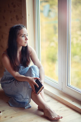 A girl at the window in the house