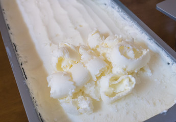 ice cream scoop, scooped out of a container with a utensil,Vanilla