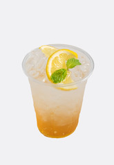 Honey lemon soda with ice in plastic glass,isolate white background