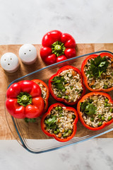 Stuffed peppers in a glass baking dish, ready for baking in the oven. healthy vegan cuisine for the whole family. comfort food