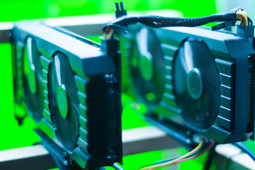Video card mining rig on the frame. In the frame are two video cards with wires.