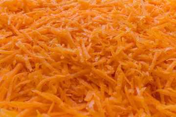 Grated fresh orange carrot close-up. Texture, background.