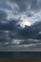 Fototapeta na wymiar Light ray pierces the cloud with aircraft cross over.