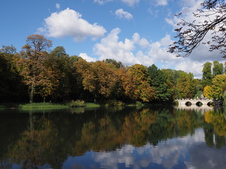 Fototapeta na wymiar Picturesque white bridge in baths park landscapes in Warsaw, european capital city of Poland in 2018 on September