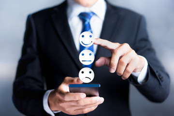 Customer service evaluation and satisfaction survey concepts. The client's hand picked the happy...