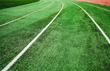 Running track with bright green artificial turf