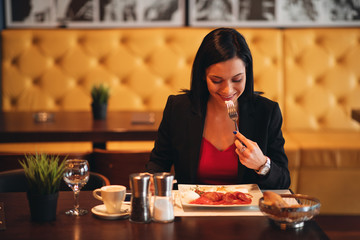 Young business woman on breakfast in a restaurant