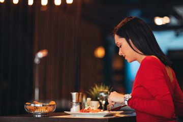 Young woman on breakfast in a restaurant