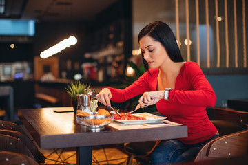 Young woman on breakfast in a restaurant