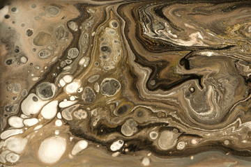 Gold marbling texture design. Beige and golden marble pattern. Fluid art.