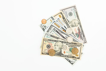 Coins with USA banknotes on white background. Flat lay, top view. Financial or business concept.