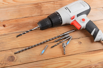 The new drill on wooden background close up