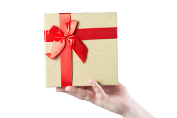 Woman hand gives present box with red ribbon isolated on white background.