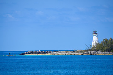 white lighthouse at entrance of Paradise Island Harbor in Nassau Bahamas © driftwood