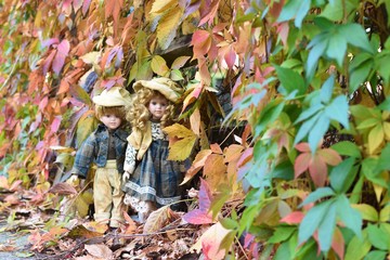 girl and boy in autumn leaves 