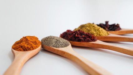 5 different spice concepts, cinnamon, chili pepper, black pepper, clove, cumin, isolated,