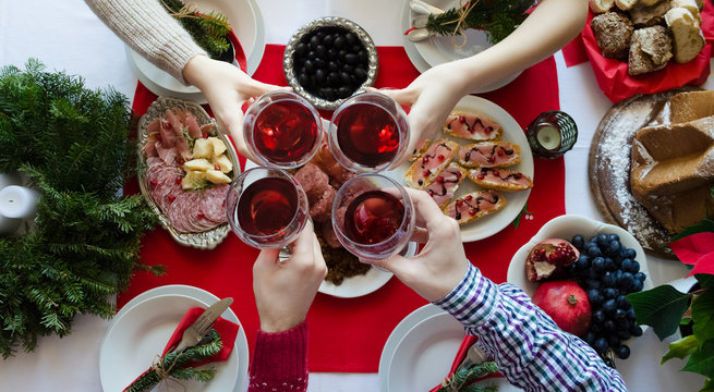 Top view of people toasting with glasses of red wine