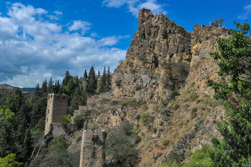 Fototapeta na wymiar The ruined wall of ancient fortress citadel Narikala in the old city of Tbilisi in Georgia.