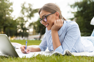 Cheerful young girl spending time at the park