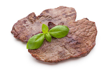 Grilled beef steaks with spices isolated on white background.