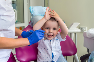Little boy patient in dentistry sitting in chair