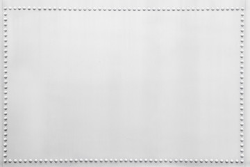 White metal plate with small rivets.