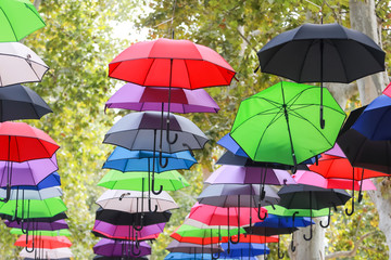 Colorful umbrellas floating in air