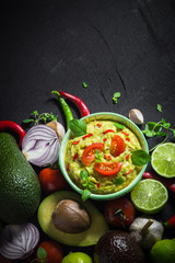 Background bowl guacamole tomato chilli pepper lime onion garlic dill and oregano