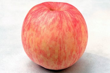 Fresh red with yellow apple isolated on white background close-up.